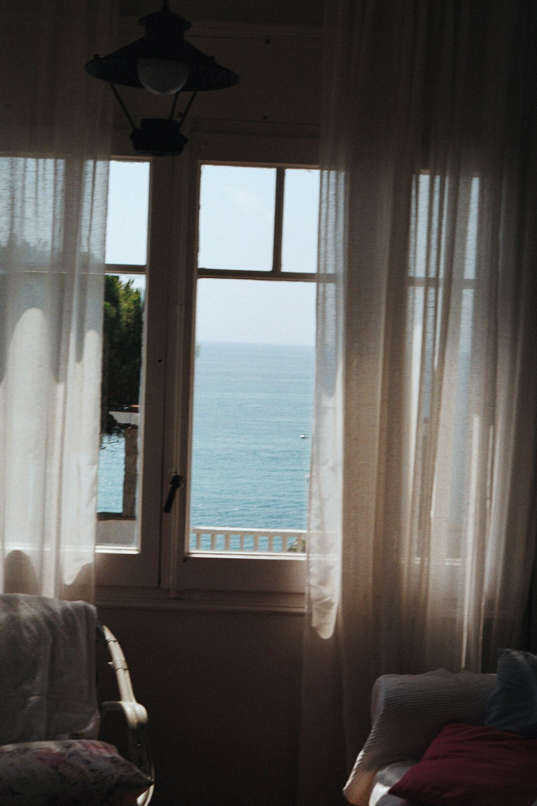 Minimalist living room with ocean view through large windows